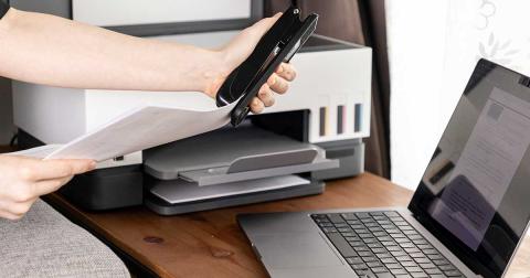 Gedruckte Dokumente werden nach dem Ausdruck am Schreibtisch weiterverarbeitet